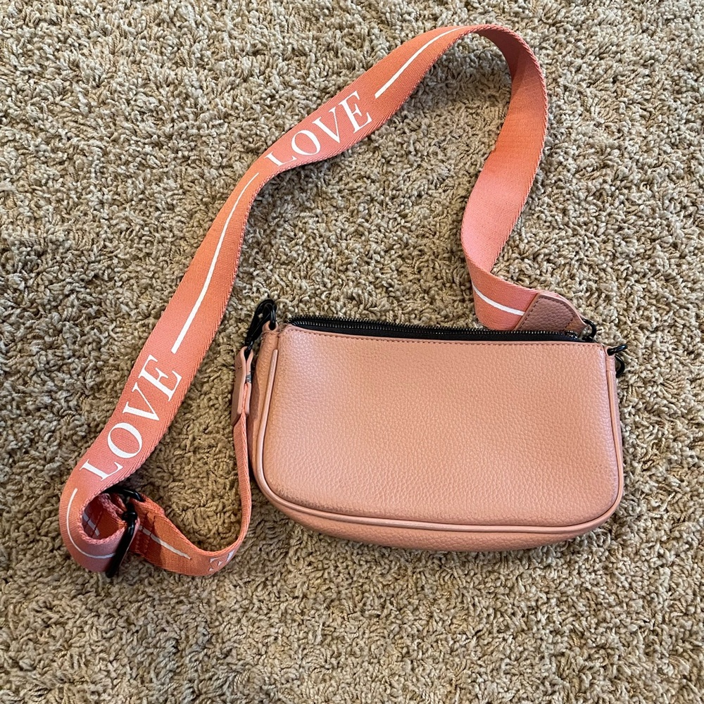 Pink Crossbody Bag with Structured Design and Metallic Hardware
